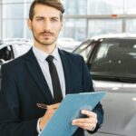 I Am the Finance Director at the Car Dealership and I Welcome You into My Cramped Windowless Office 28